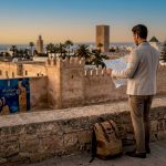 Traveler overlooking Rabat skyline sunrise