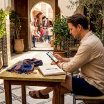 Traveler planning in Marrakech café, seasonal weather